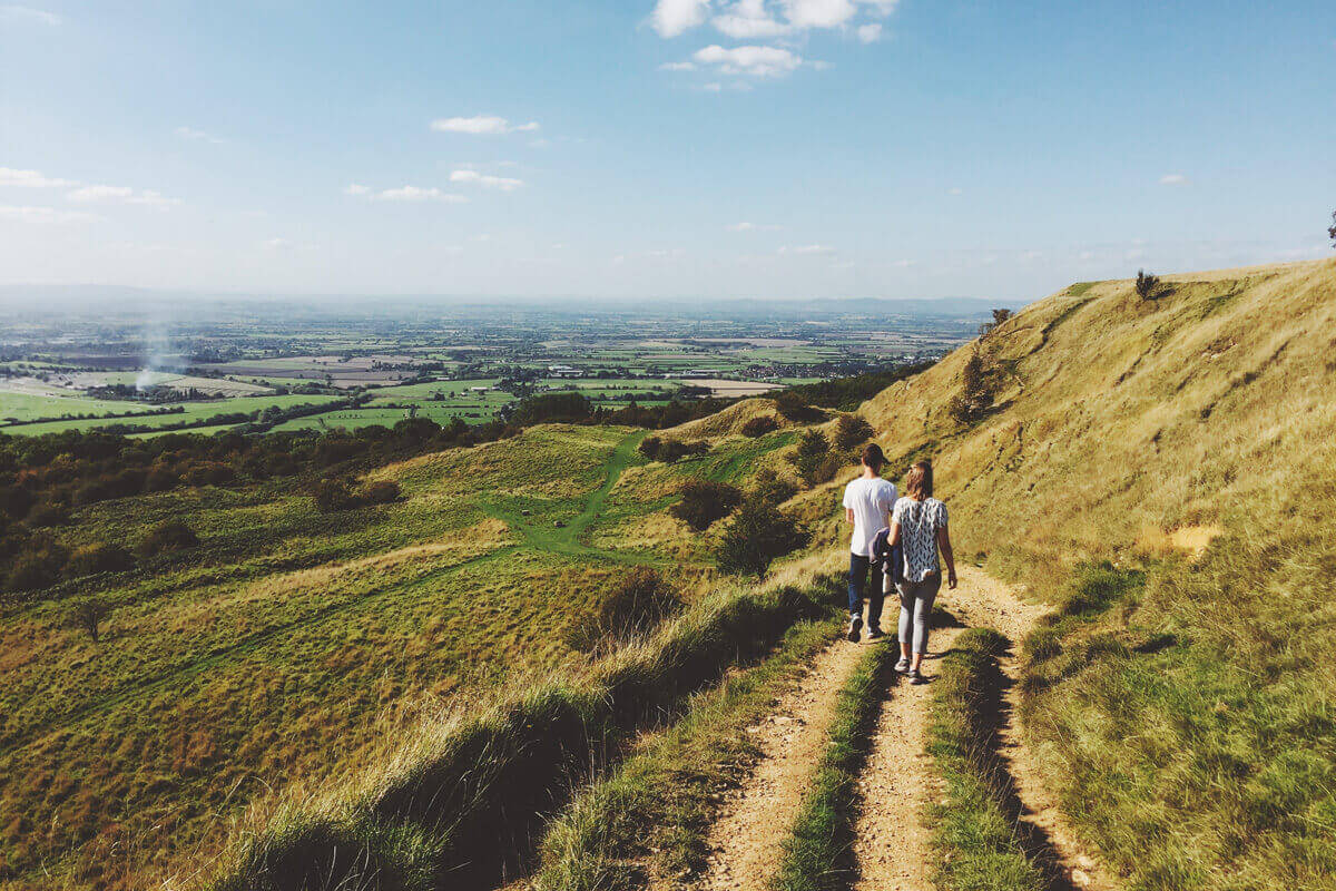 Couple Hiking Down a Mountain