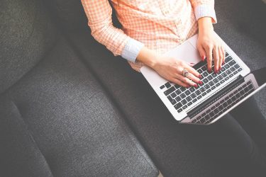 Girl Writing on Laptop