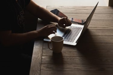 Young startup CEO using laptop.