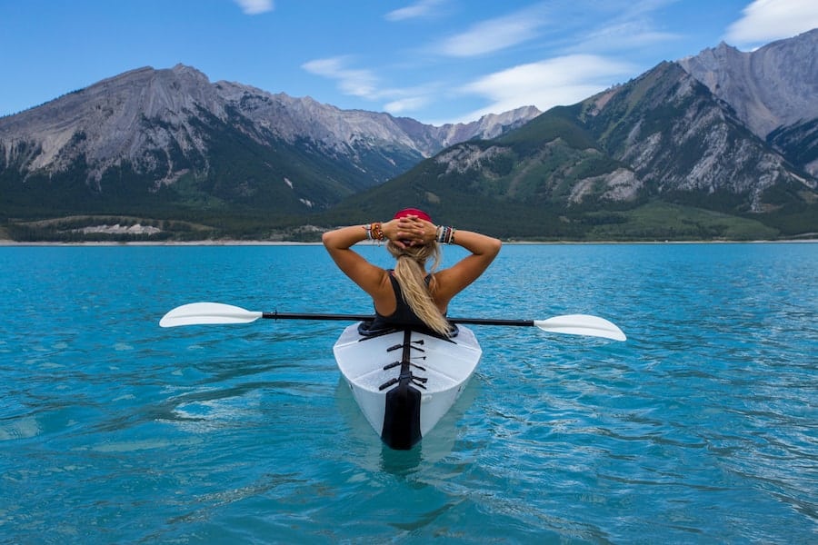 Woman resting after kayaking to the middle of the lake