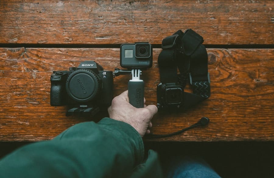 Man Picking up gopro camera on tripod (1)