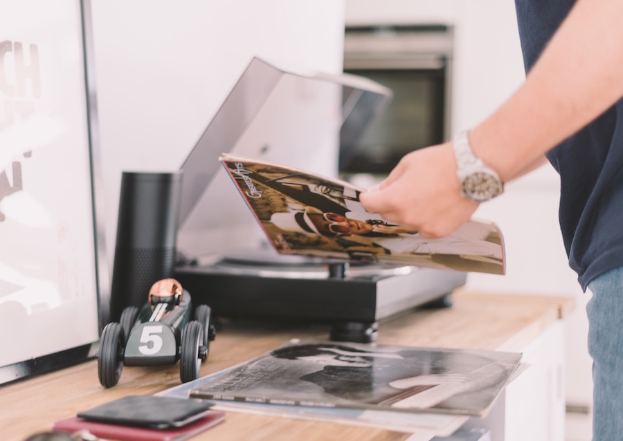 young hipster man playing vinyl music in the morning 