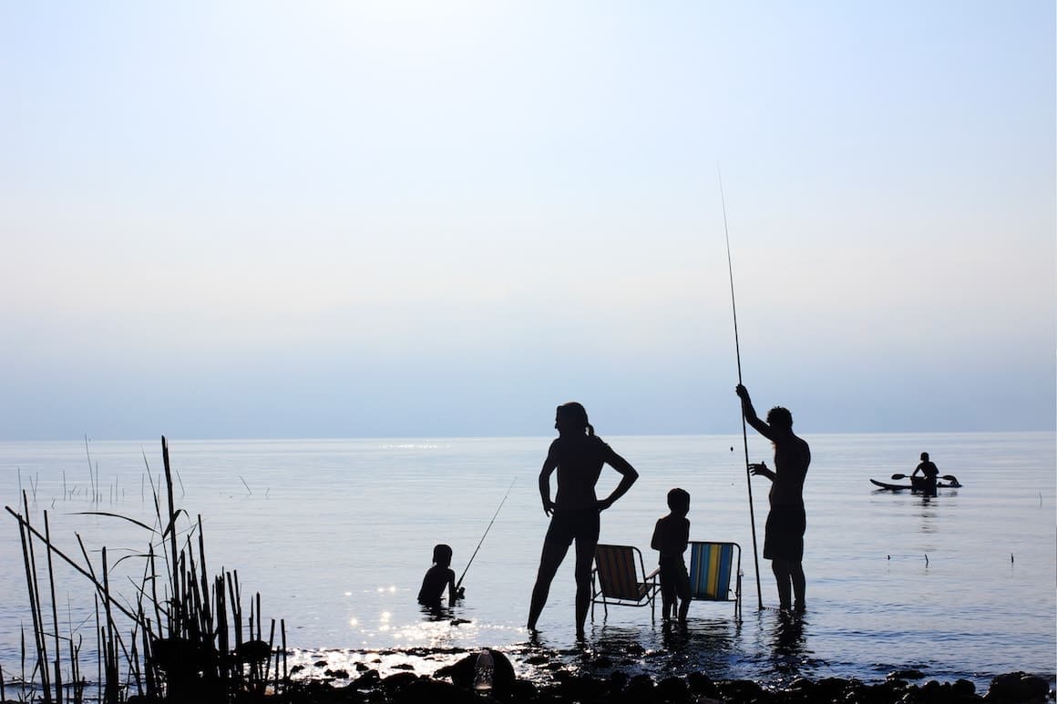 Family fishing together at the lake