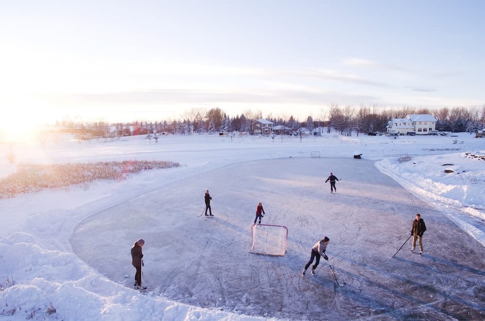 Group of Friends playing ice hockey on a cold winter day in canada