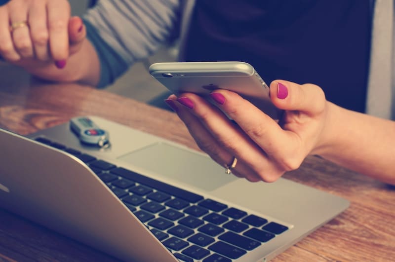 Young Business Woman checking emails on her smartphone