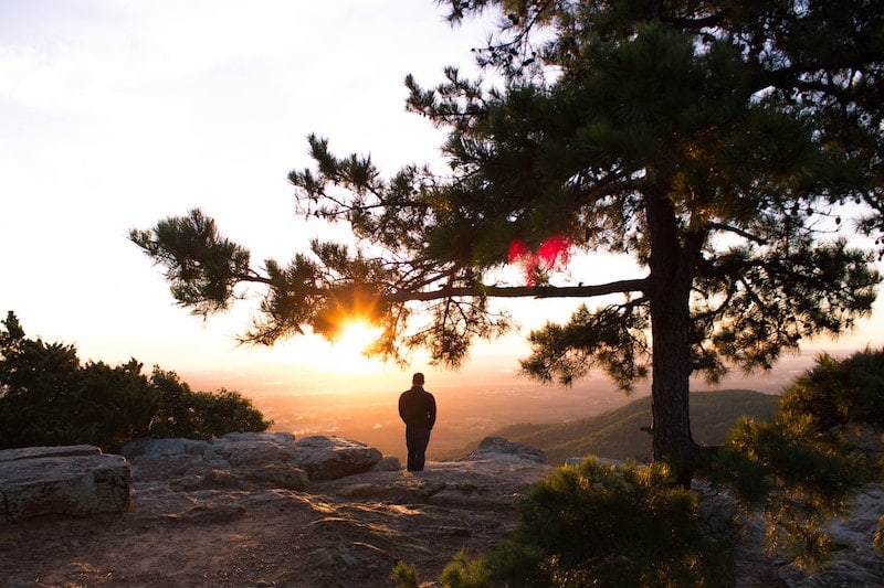 Young man watching sunrise