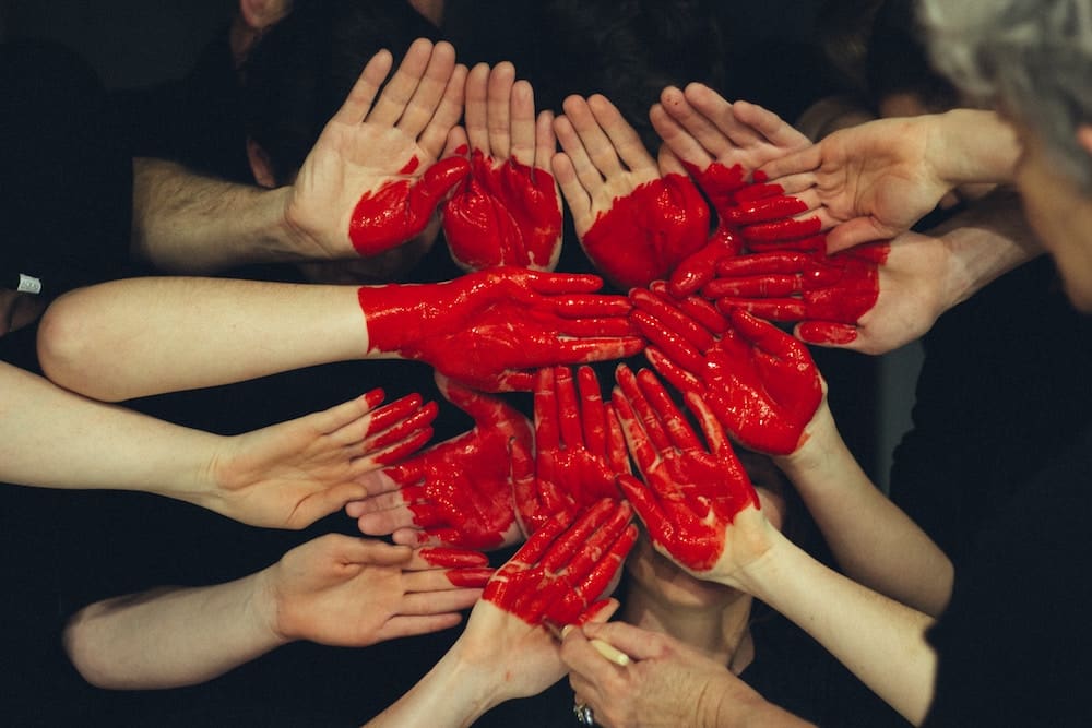 Symbol of a heart created with multiple hands