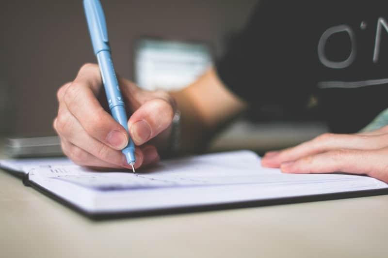 Man writing down his idea inside his journal