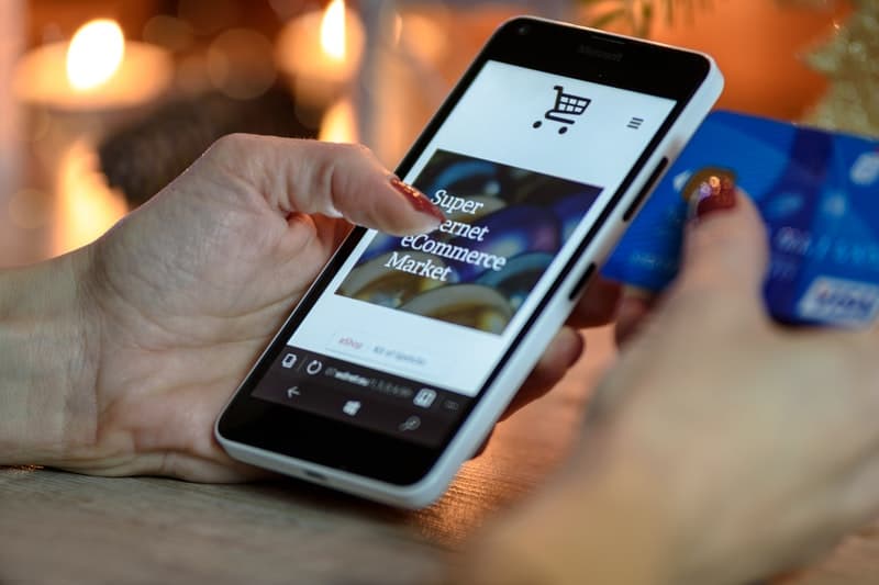 Woman using smartphone to make an online purchase