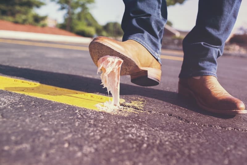 man-accidently steps on bubble gum with his shoes