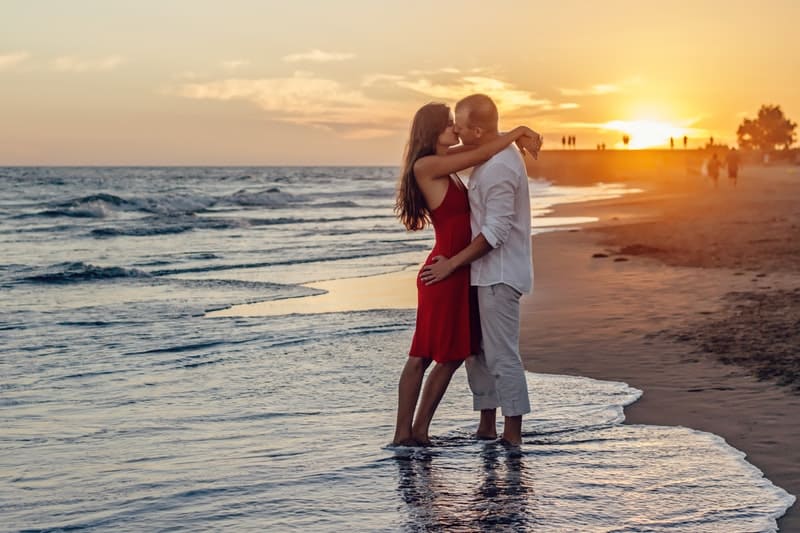 Romantic couple kissing during evening at the beach