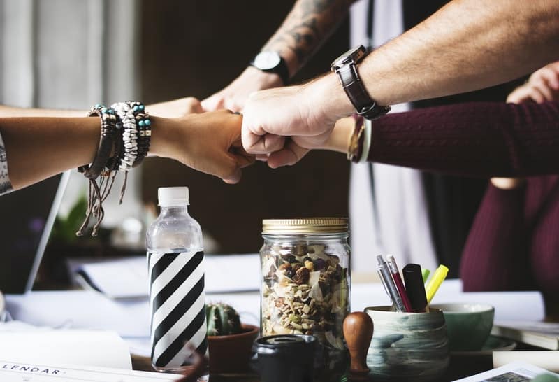 colleagues-cooperation-fist-bump-fists