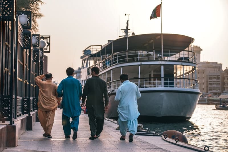 Group of friends walking next to the canal of old dubai