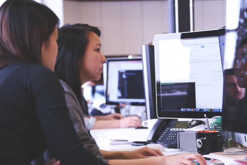 Two women working together on a project at the office