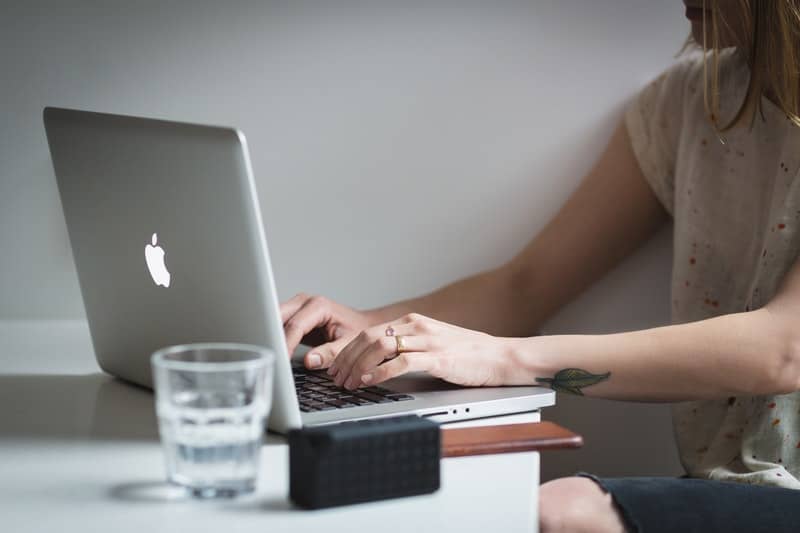 Woman Typing on a macbook pro