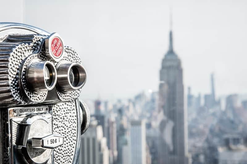 binoculars looking out on New York City during day