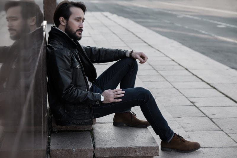 black leather jacket man sitting-in-city