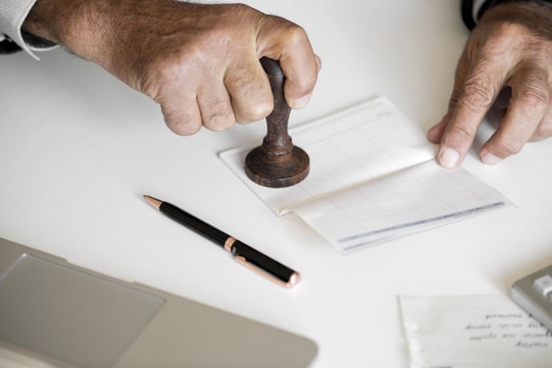 Person holding a brown stamp