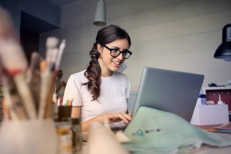 photo of woman using her laptop