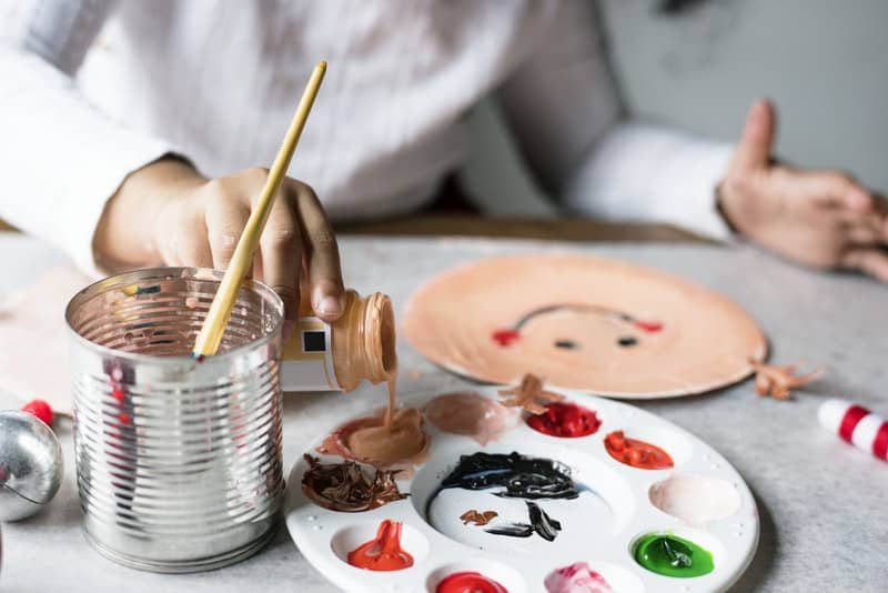 woman pouring down a brown paint