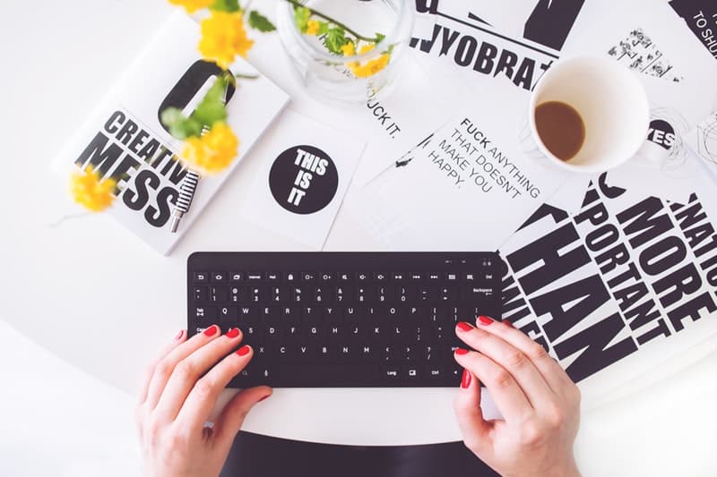 girl-writing-on-a-black-keyboard