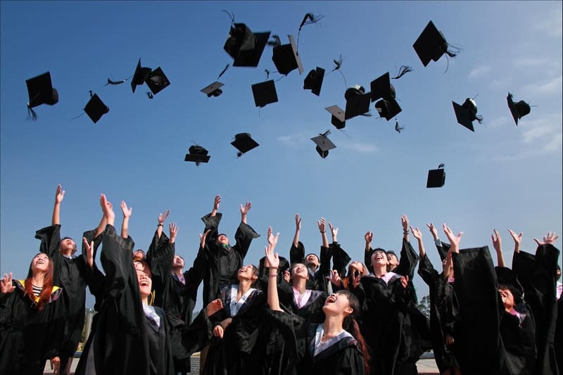 graduation ceremony of students throwing their hats in the air