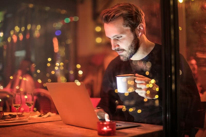 young man using a laptop to find women to date