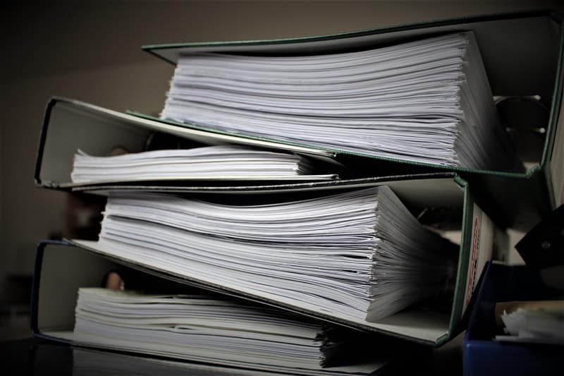 batches of paperwork stacked on a desk