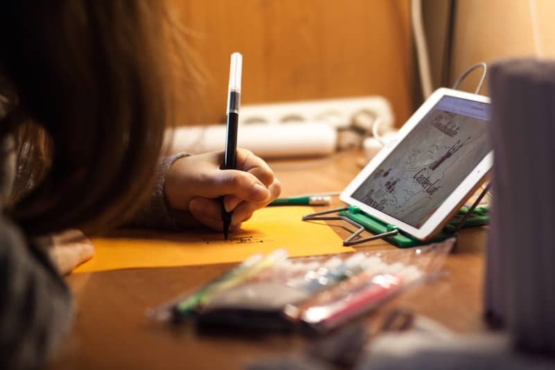 Child using a tablet to do homework