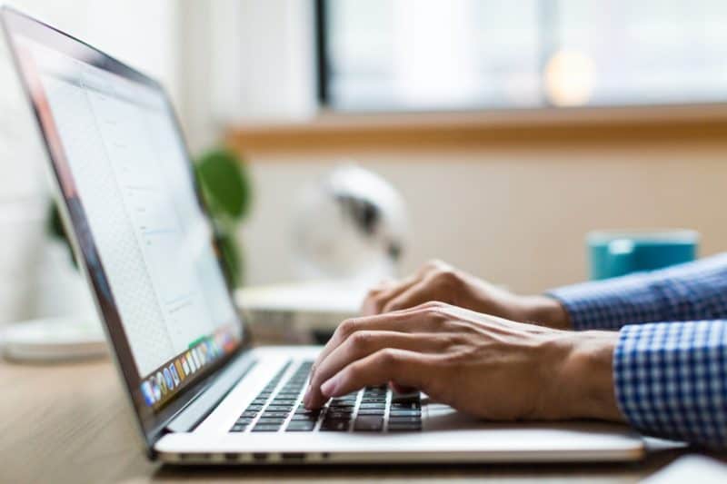 Person Writing on a laptop