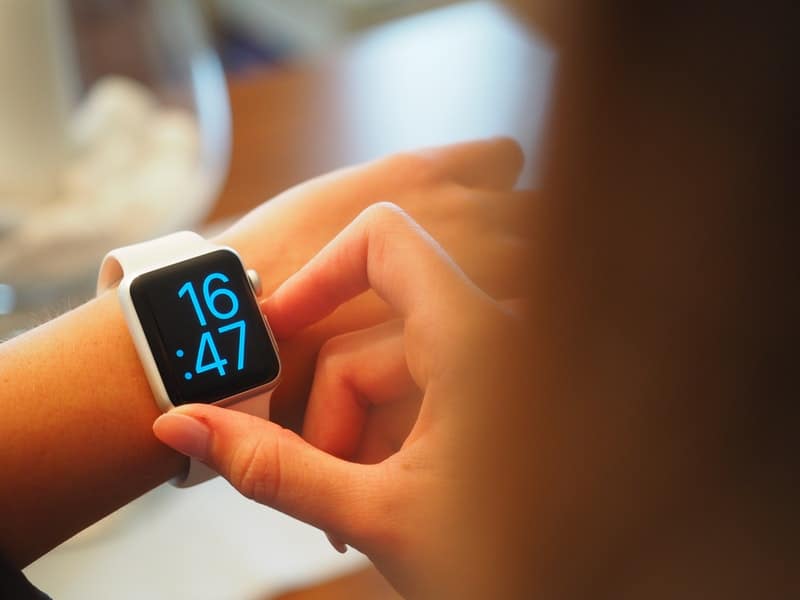 Young woman checking her apple watch