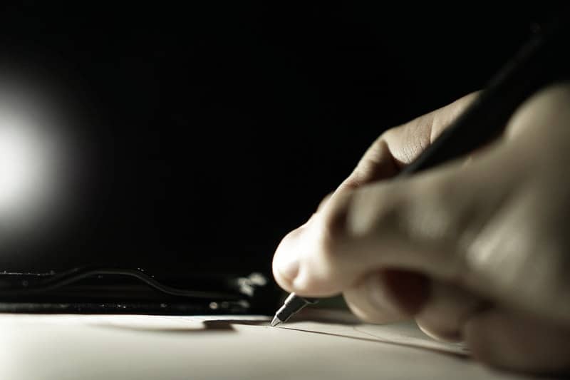 close up of a hand using a pen