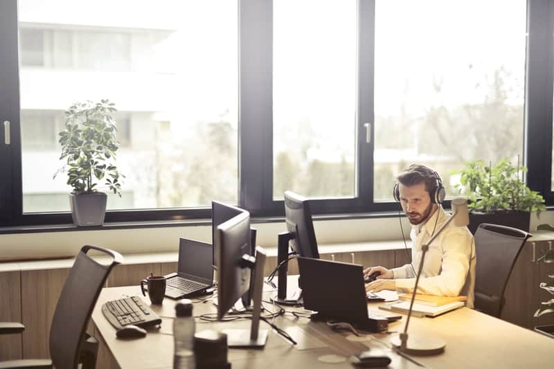 man with headphones using computer