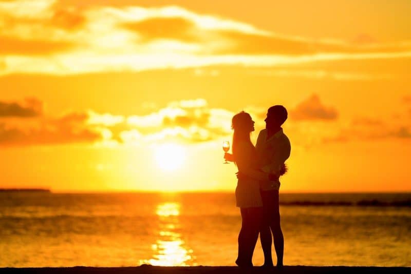 Couple Standing in the Seashore Hugging Each Other during Sunset