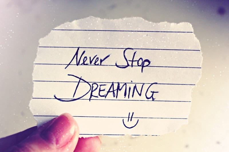 Never stop dreaming writting on a small note