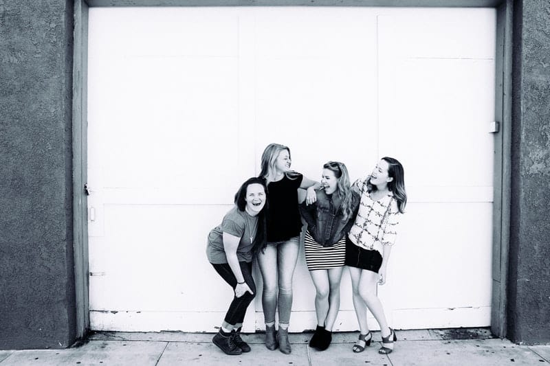 grayscale photography of four women friends