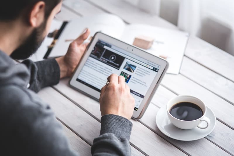 men using a tablet to learn a new business skill online