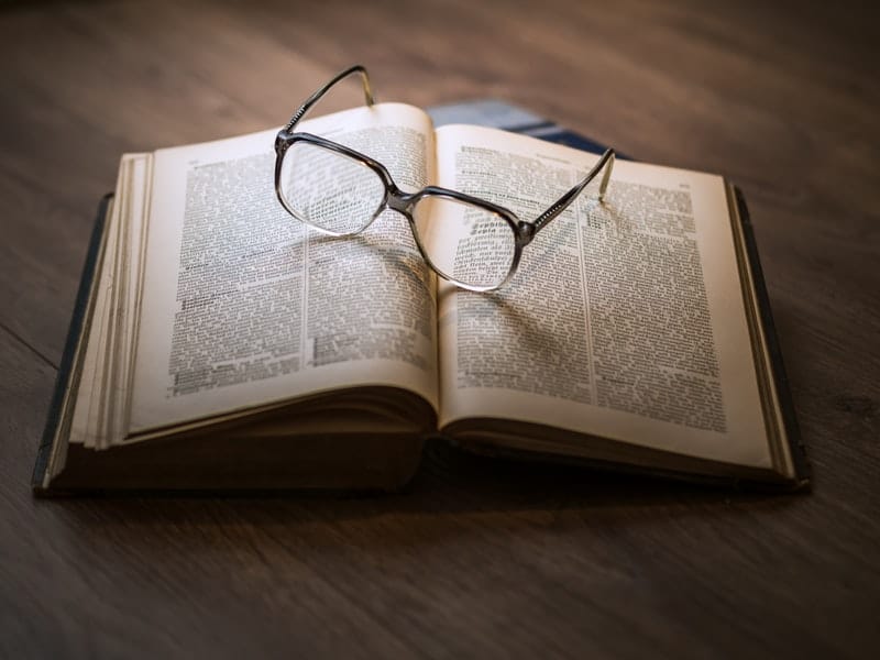 nostalgic reading glasses laying on a book