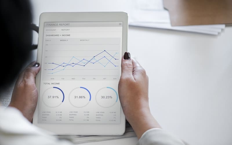 woman looking over financial reports on her ipad