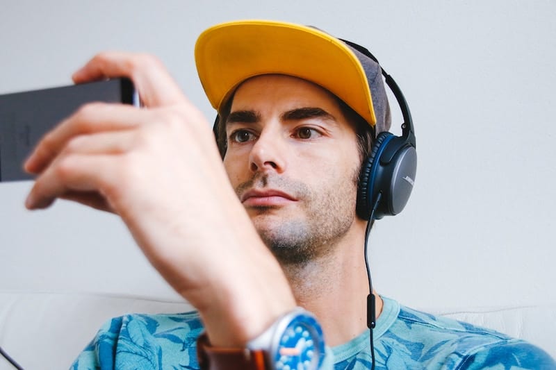 Man Using his smartphone to watch a Youtube Video
