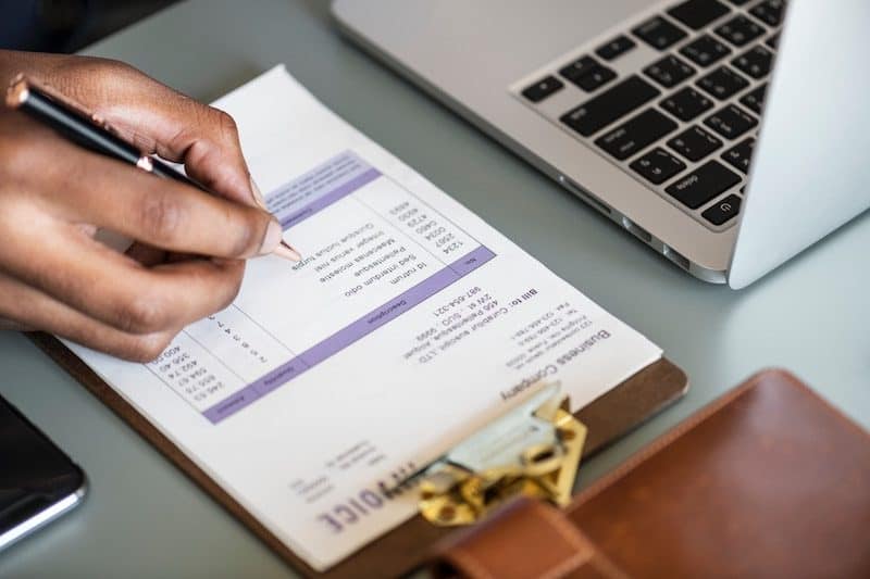 Man writing an Invoice for a Client