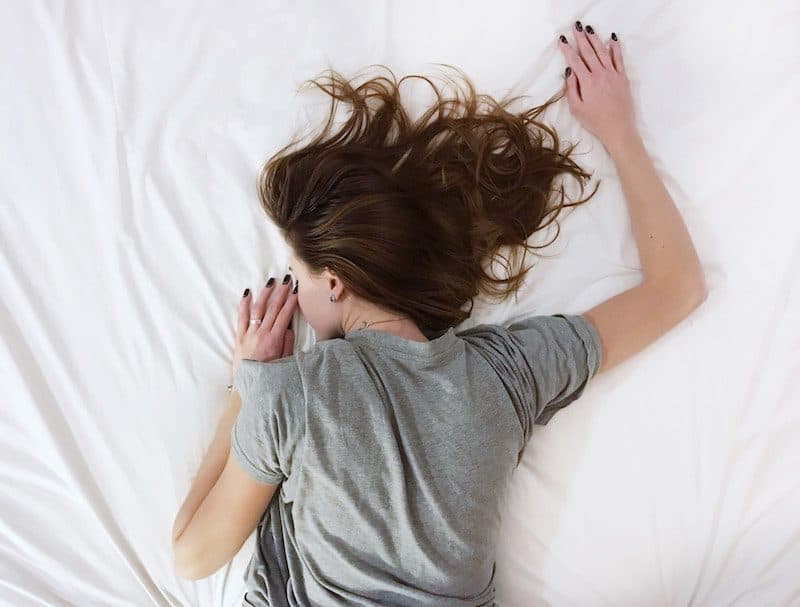 young woman testing a mattress a the store