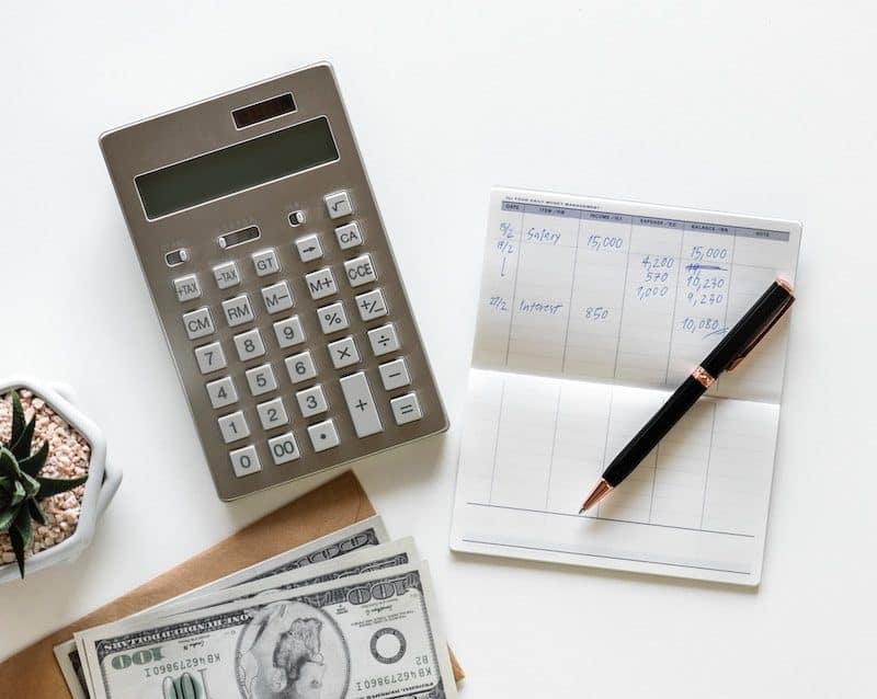 Calculator and Check book laying on the table