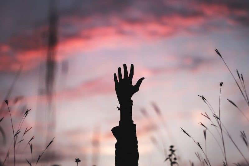 Hand Reaching for The Sky During Dusk