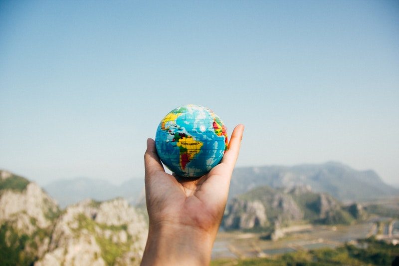 Man Holding Globe