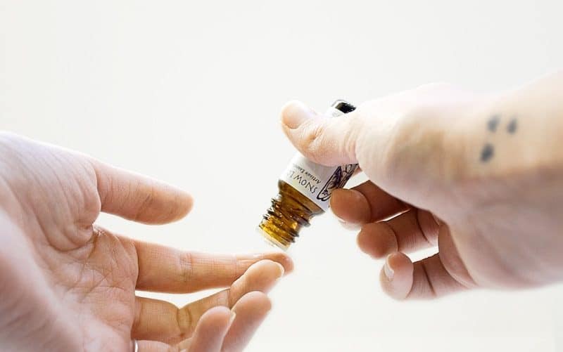 Man Pouring cbd oil on his finger