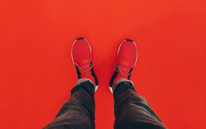 Man Standing on top of a red surface