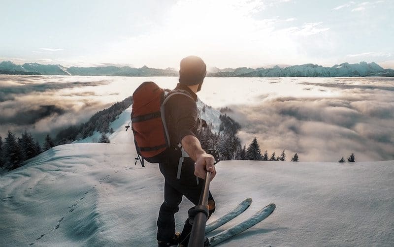 Man Using gopro to film himself Skiing