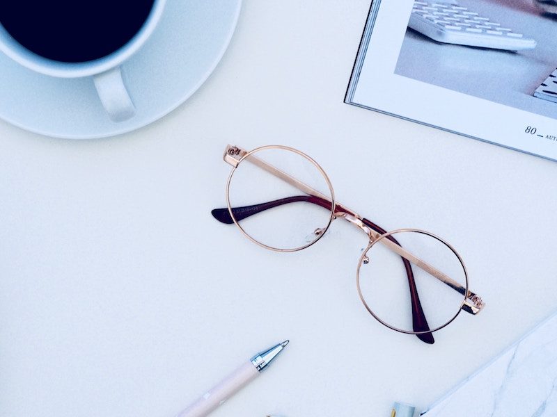 Reading Glasses on a White Desk