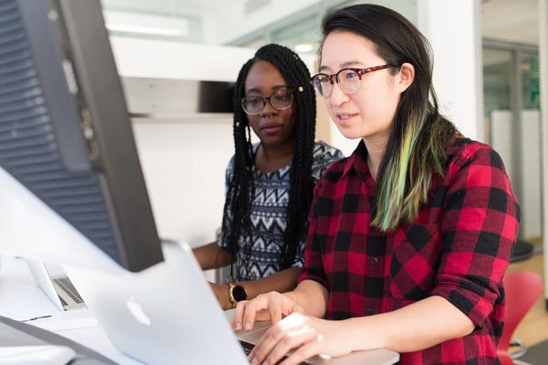 Two women working on creating a website